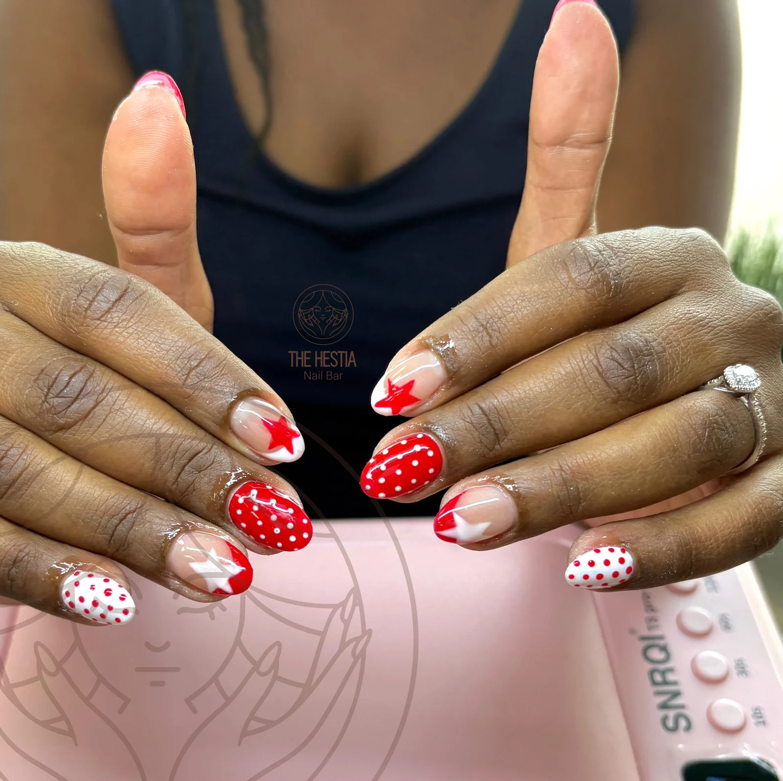Red star and polka-dot nail art by The Hestia Nail Bar